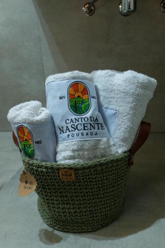 a basket filled with towels on top at Pousada Canto da Nascente in Monte Verde