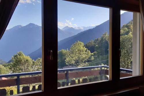 a view from a window of a mountain view at CASA VIDI in Madonna di Campiglio