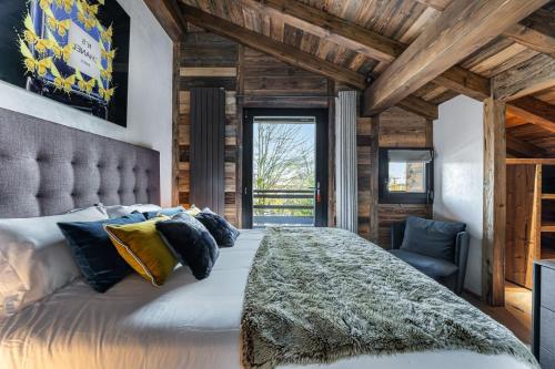 a bedroom with a large bed and a chair at Perfect for moments with friends or family in Oberstaufen