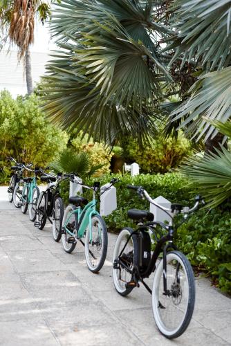 a row of bikes parked next to each other on a sidewalk at Ambergris Cay - Private Island All-Inclusive in Big Ambergris Cay