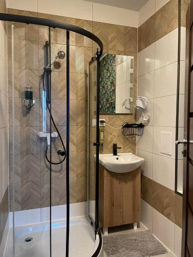 a bathroom with a shower and a sink at Prosecco Rynek 14 in Inowrocław