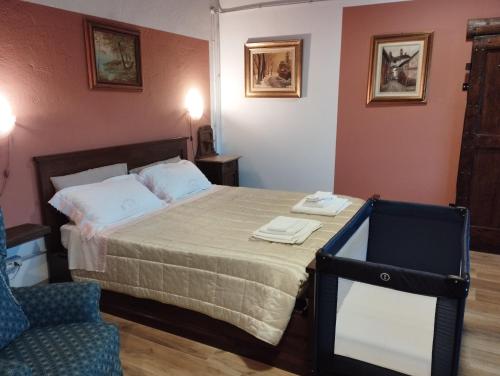 a bedroom with a bed with a chair and a mirror at Casa del Puck in Canale