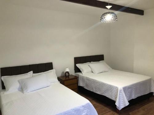 מיטה או מיטות בחדר ב-Pousada Litorânea
