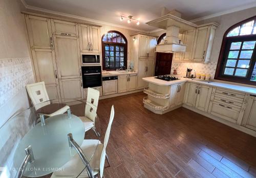 a large kitchen with white cabinets and a table at Villa Sally in Adeje