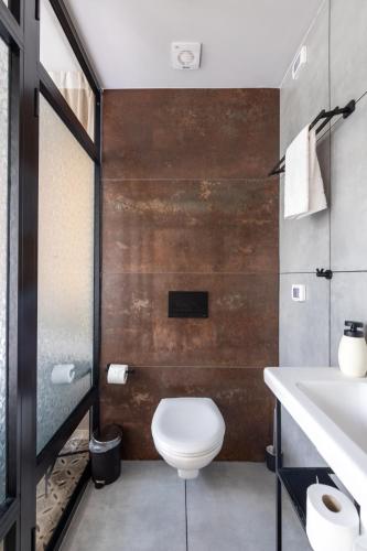 a bathroom with a toilet and a sink at Levinski Market Hotel in Tel Aviv