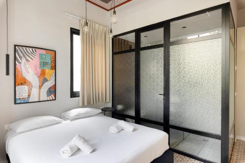 two beds sitting next to each other in a room at Levinski Market Hotel in Tel Aviv