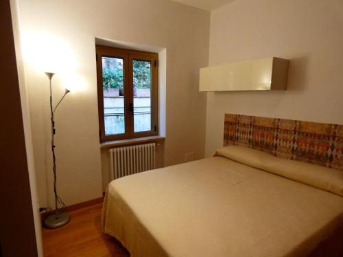 a bedroom with a bed and a window at Le dimore di Esiodo in Rome
