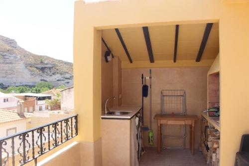 a kitchen with a balcony with a view at Mirada al Júcar in La Recueja