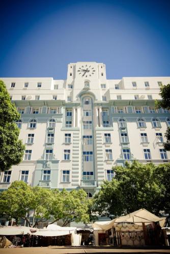 a large white building with a clock on it at ONOMO Hotel Cape Town – Inn On The Square in Cape Town