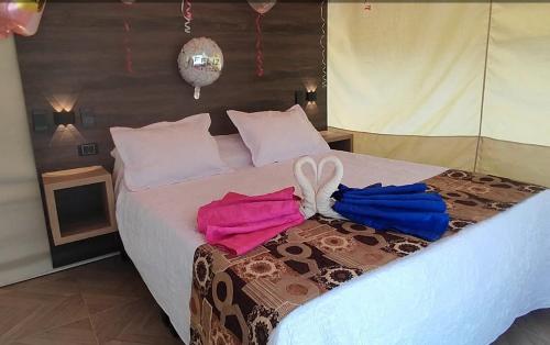 a bedroom with a bed with two towels on it at Glamping Paraíso Escondido in Anapoima