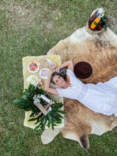 a woman laying on top of a large teddy bear at Uaná Etê EVEN GLAMPING Experiências de Charme in Engenheiro Paulo de Frontin
