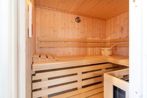 a sauna with wooden walls and a wooden floor at Ferienhaus Maira, mit Garten und Sauna in Greetsiel