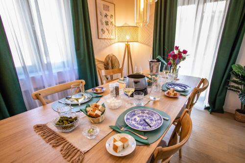 a wooden table with plates and bowls of food on it at Chalet Antoine serviced Apartments by Mirabeau in Zermatt