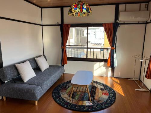 a living room with a couch and a table at Shima Akari - Vacation STAY 66905v in Tonosho