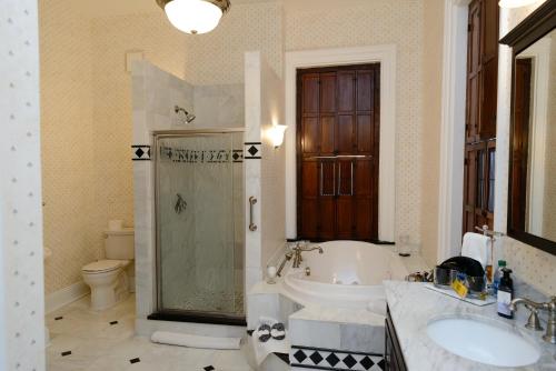 a bathroom with a tub and a sink and a toilet at The Big Brickhouse in Mercer