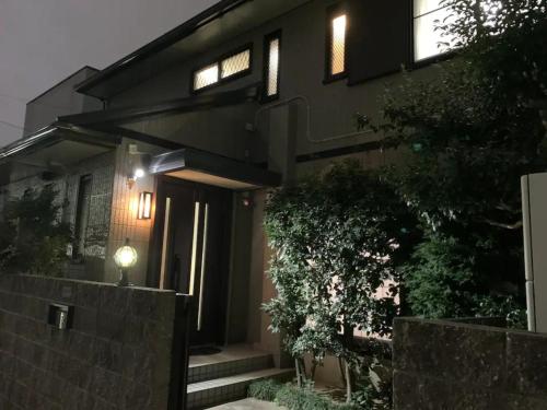 a black house with a fence in front of it at Azuma Taku - Vacation STAY 13741 in Kanie