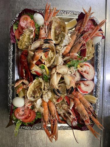 a plate of food with shrimp and vegetables on a table at De Eenhoorn in Oostburg
