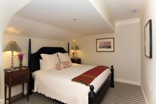 a bedroom with a bed and a table with a lamp at Saybrook Point Resort & Marina in Old Saybrook