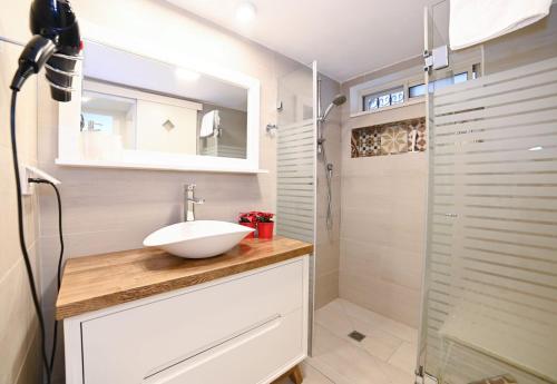 a bathroom with a sink and a shower at Josephine's 2Bdrm apt 50M to Bahai gardens in Haifa