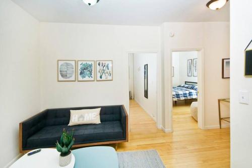 a living room with a couch and a bedroom at 102-1A Best Value 2BR Apt Near Central Park in New York