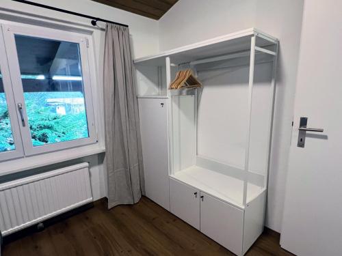 a room with a white closet with a window at Casa Campanula in Laax