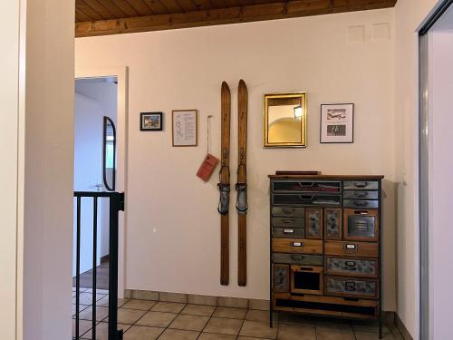 a room with skis on the wall and a cabinet at Casa Campanula in Laax