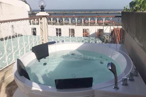 a jacuzzi tub on top of a balcony at AmazINN Places Rooftop and Jacuzzi I in Panama City