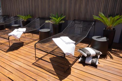a group of chairs and towels on a wooden floor at Hotel Bys Palermo in Buenos Aires