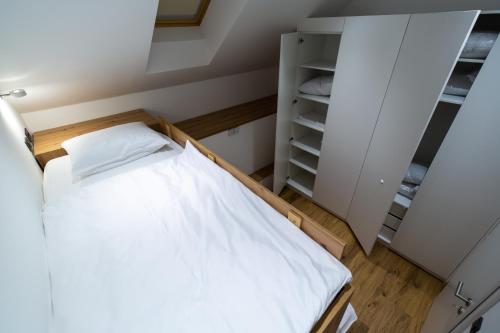 a small room with a bed and a closet at AppPrusnik in Ljubljana