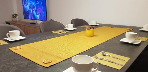 a table with yellow napkins on top of it at AppPrusnik in Ljubljana