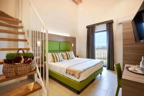 a bedroom with a bed and a staircase and a television at Brussa Horse Oasi in Caorle