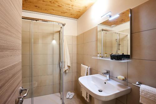 a bathroom with a sink and a shower at Brussa Horse Oasi in Caorle