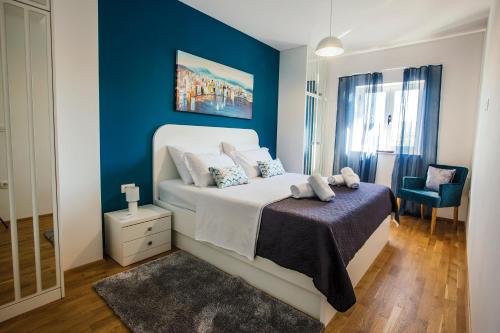 a bedroom with a bed and a blue wall at VILLA G., Relaxing and Unique nest of Enjoyment in Imotski