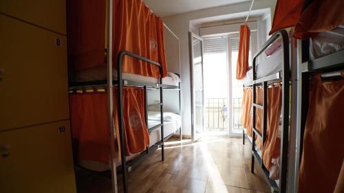 a room with several bunk beds and a window at Summer Cádiz in Cádiz