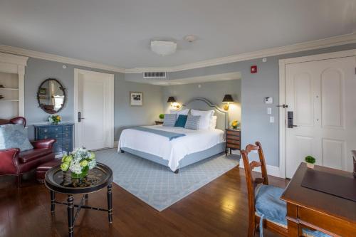 a bedroom with a bed and a living room at Saybrook Point Resort & Marina in Old Saybrook