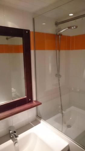 une salle de bain avec un lavabo et une douche dans l'établissement ALAIN, à Tignes