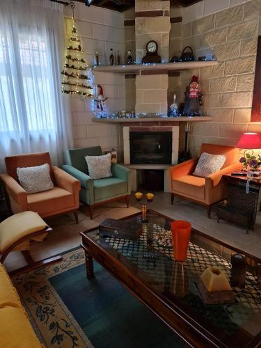 a living room filled with furniture and a christmas tree at House of Roses in Limassol