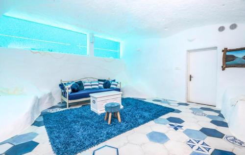 a blue room with a blue couch and a blue rug at VILLA G., Relaxing and Unique nest of Enjoyment in Imotski