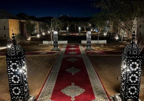 a park at night with a red carpet and lights at Merzouga best camp in Merzouga