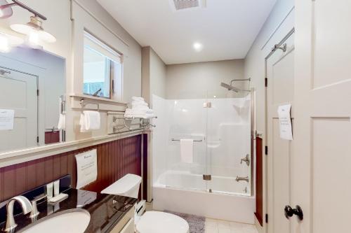 a bathroom with a shower and a sink and a toilet at Wolcott Wonder in Lake Elmore