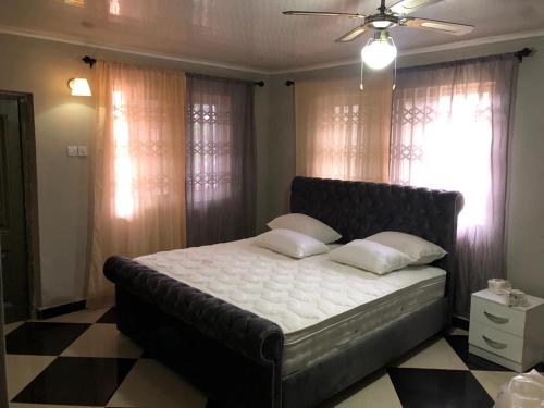 a bed with two pillows on it in a bedroom at Well presented apartment with 2 master bedrooms. in Freetown