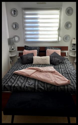 a bedroom with a large bed with a window at La Nomade in Marckolsheim