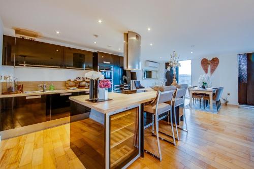 a kitchen with a counter and a dining room at Spacious 3-Bed Penthouse with City Sky Line Views in Sheffield