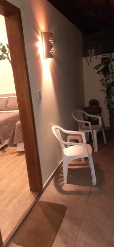 a room with two chairs and a table and a light at Familien Haus Pousada in Pomerode