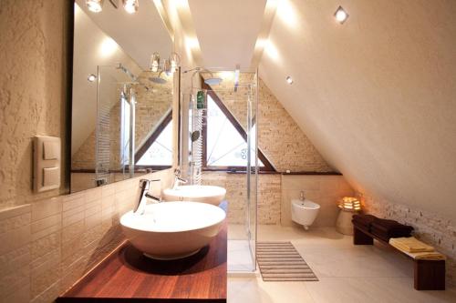 a bathroom with a sink and a glass shower at Apartment U Lejbusia in Kościelisko