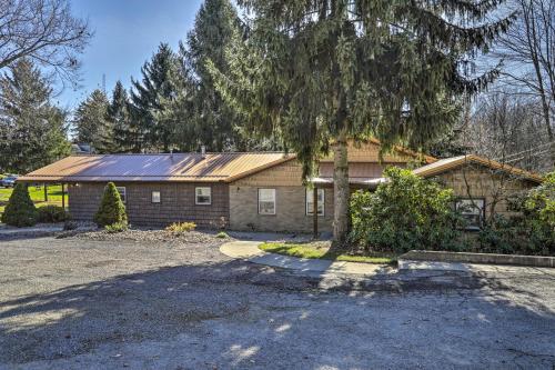 a house with a tree in front of it at Near Mines and Meadows Spacious Home with Game Room in Beaver Falls