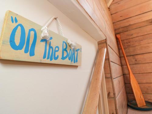 a sign that says on the brink hanging on a wall at Kipper Lodge in Dartmouth
