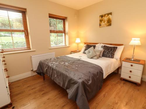 a bedroom with a large bed and two windows at Rocklands House in Beaufort
