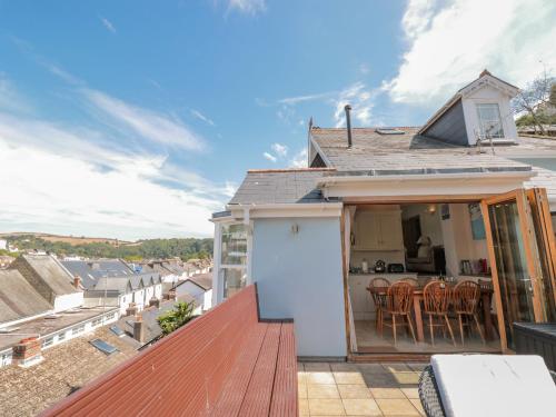 a roof deck with a view of a house at Kipper Lodge in Dartmouth