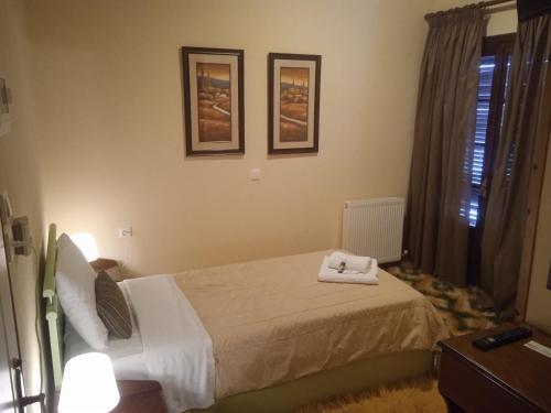a bedroom with a bed with two towels on it at Thiamis Guesthouse in Doliana